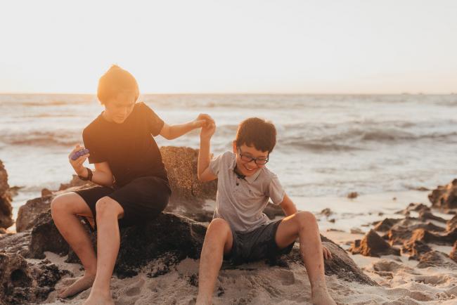 brothers messing around on sand with Perth family photographer Alana Prosper Photography at Burns Beach