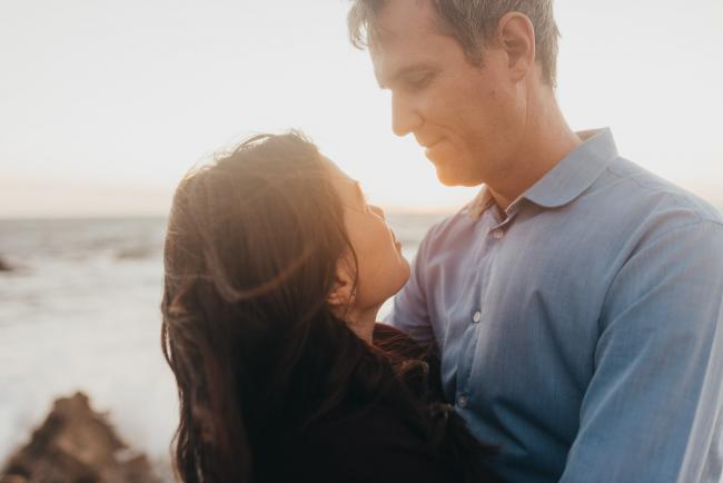 couple looking at each other with Perth family photographer Alana Prosper Photography at Burns Beach