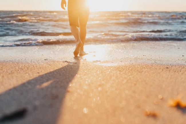 boy walking towards ocean from sand with Perth family photographer Alana Prosper Photography at Burns Beach