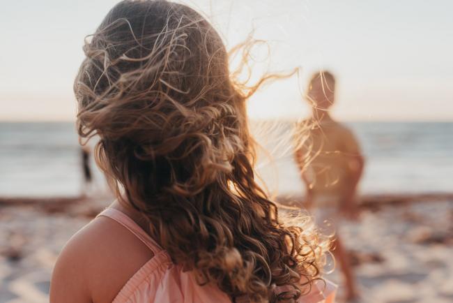 little girls hair blowing in the wind with family photographer Perth at Burns Beach, Alana Prosper Photography