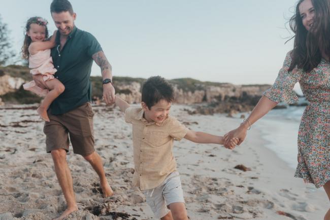 family of five running on the beach with family photographer Perth at Burns Beach, Alana Prosper Photography