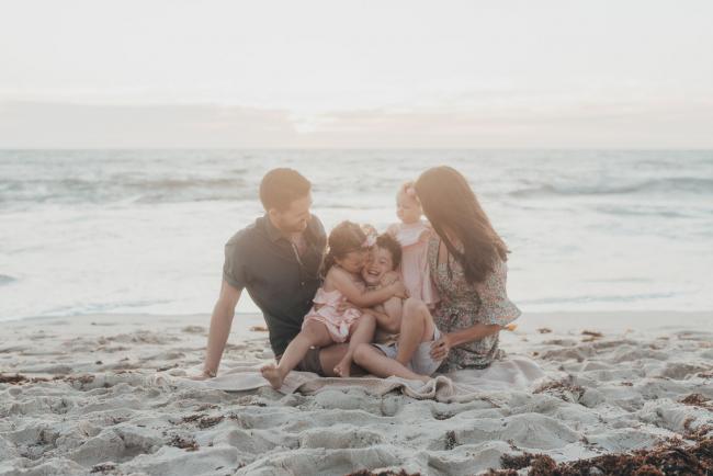 family of 5 sitting on the beach with family photographer Perth at Burns Beach, Alana Prosper Photography