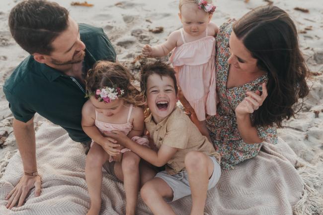 family of 5 sitting on the beach with family photographer Perth at Burns Beach, Alana Prosper Photography