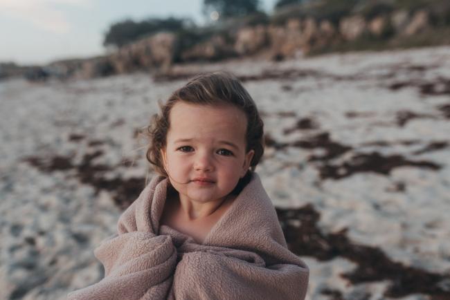 little girl with blanket on the beach with family photographer Perth at Burns Beach, Alana Prosper Photography