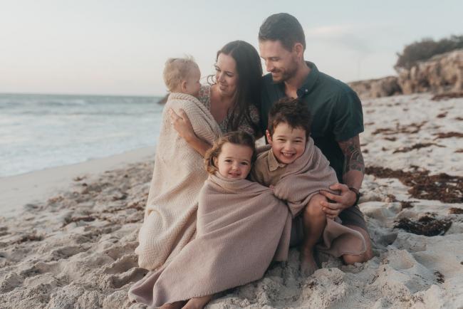 family of five with blanket on the beach with family photographer Perth at Burns Beach, Alana Prosper Photography