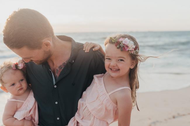 Father holding daughters on the beach with family photographer Perth at Burns Beach, Alana Prosper Photography