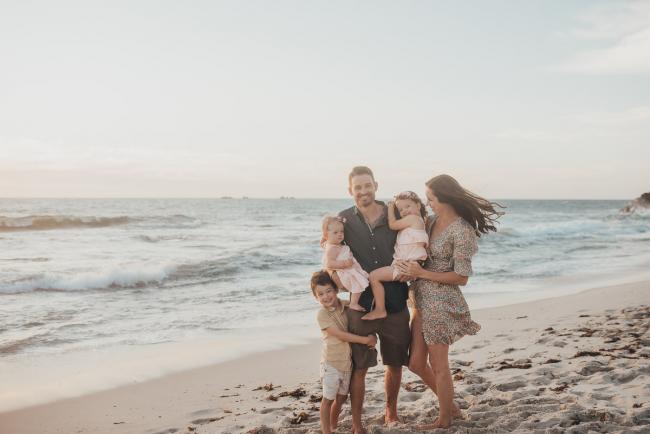 mother and father with three kids on the beach with family photographer Perth at Burns Beach, Alana Prosper Photography