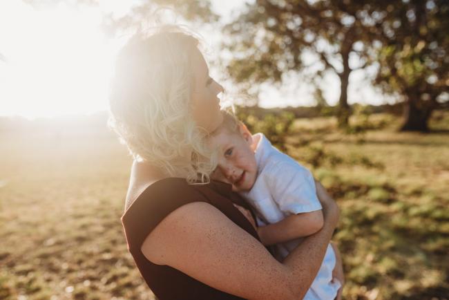 Son cuddling into mother during golden hour at Perry's Paddock with Perth Family Photographer Alana Prosper Photography