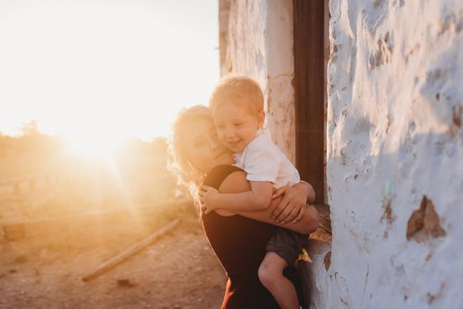 mother hugging son during golden hour at Perry's Paddock with Perth Family Photographer Alana Prosper Photography