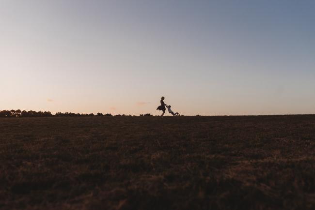 silhouette of mother spinning with son during golden hour at Perry's Paddock with Perth Family Photographer Alana Prosper Photography