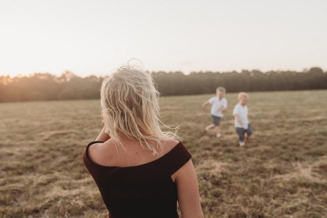 mother watching sons play during golden hour at Perry's Paddock with Perth Family Photographer Alana Prosper Photography