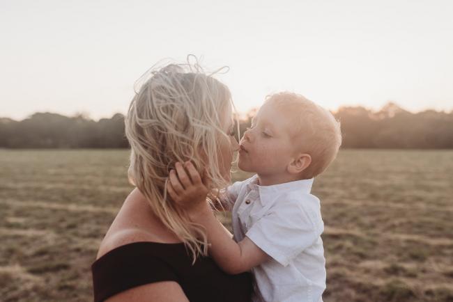 son kissing mother during golden hour at Perry's Paddock with Perth Family Photographer Alana Prosper Photography