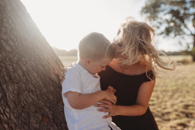 mother kissing son's head during golden hour at Perry's Paddock with Perth Family Photographer Alana Prosper Photography