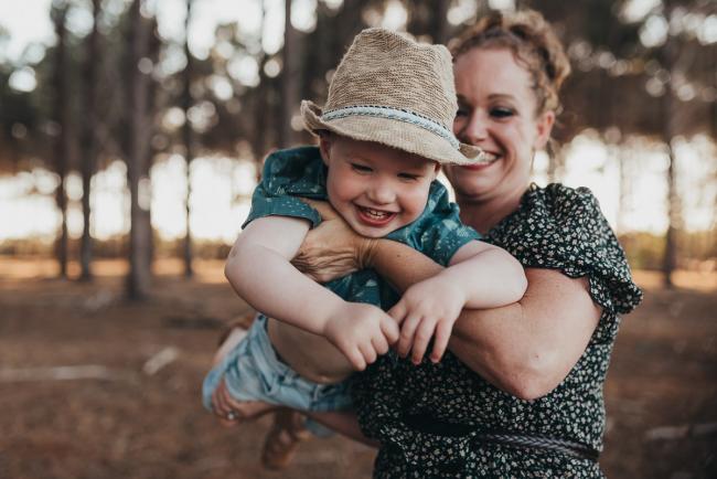 mother flying little boy through the air during Perth family photography session at The Pines Perth with Alana Prosper Photography