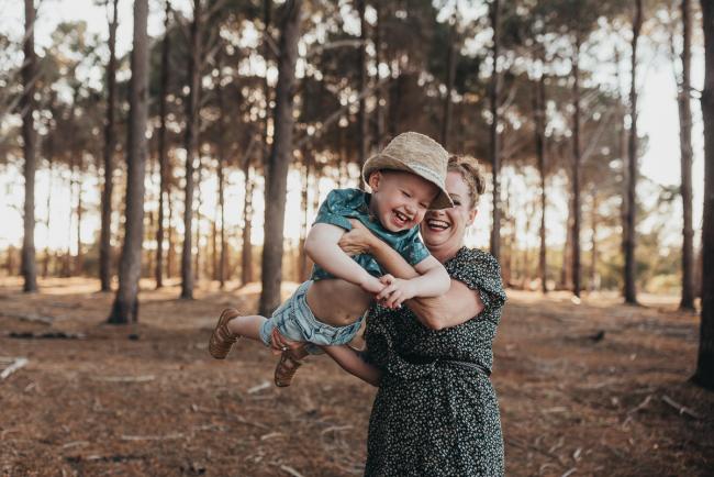 mother flying little boy through the air during Perth family photography session at The Pines Perth with Alana Prosper Photography