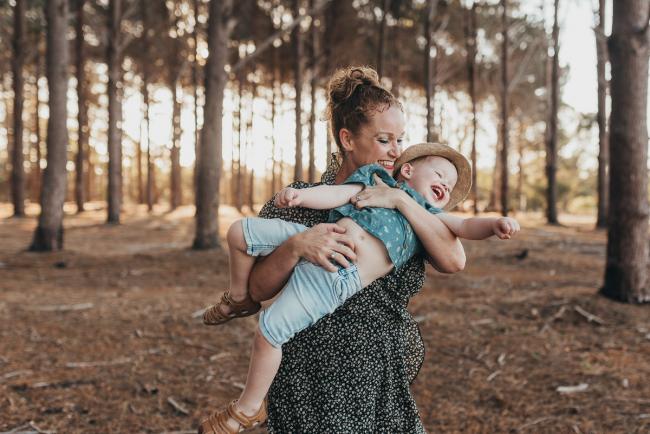mother holding little boy who is laughing during Perth family photography session at The Pines Perth with Alana Prosper Photography