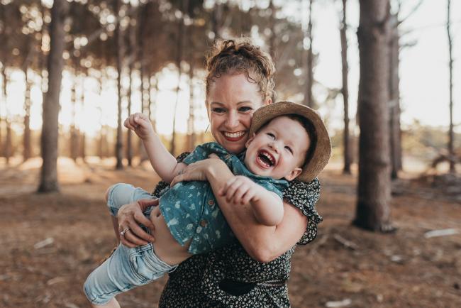 mother holding little boy who is laughing during Perth family photography session at The Pines Perth with Alana Prosper Photography
