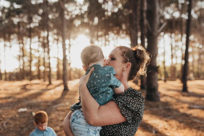 mother kissing son during Perth family photography session at The Pines Perth with Alana Prosper Photography