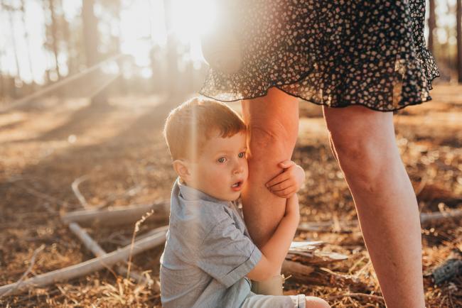 little boy hugging legs of mother during Perth family photography session at The Pines Perth with Alana Prosper Photography