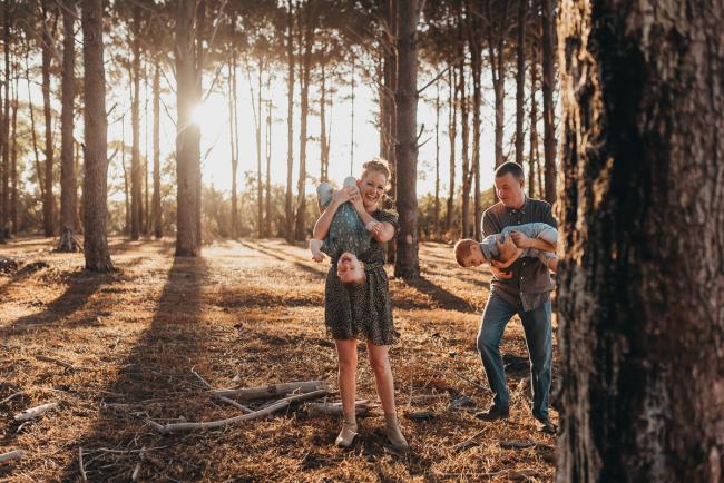 Parents holding boys upside down during Perth family photography session at The Pines Perth with Alana Prosper Photography