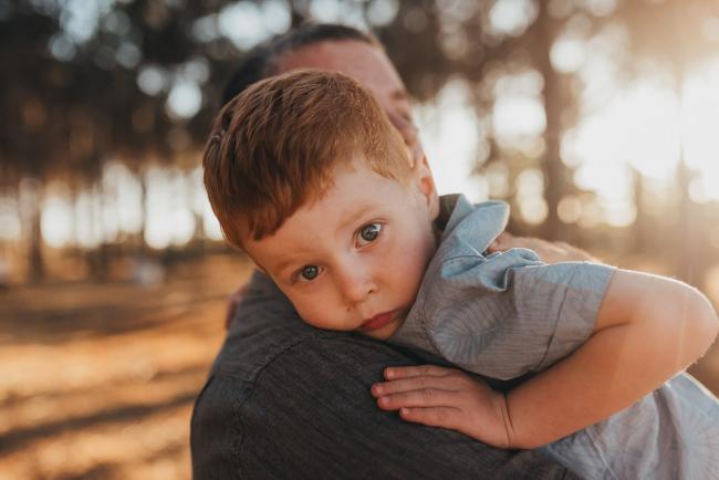 Little boy hugging father during Perth family photography session at The Pines Perth with Alana Prosper Photography