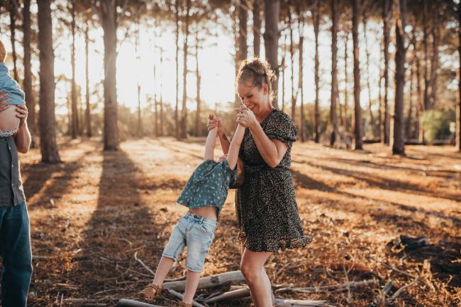 mother spinning son around during Perth family photography session at The Pines Perth with Alana Prosper Photography