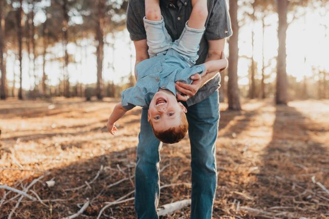 Father holding son upside down during Perth family photography session at The Pines Perth with Alana Prosper Photography