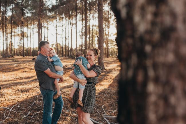 Parents holding sons during Perth family photography session at The Pines Perth with Alana Prosper Photography
