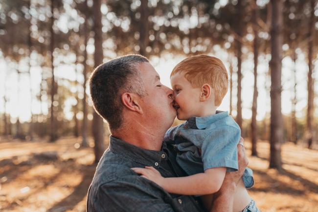 Father kissing son during Perth family photography session at The Pines Perth with Alana Prosper Photography