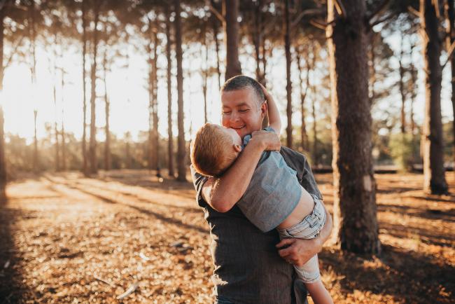 Father holding son during Perth family photography session at The Pines Perth with Alana Prosper Photography