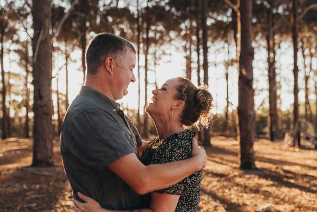 Couple smiling at each other during Perth family photography session at The Pines Perth with Alana Prosper Photography