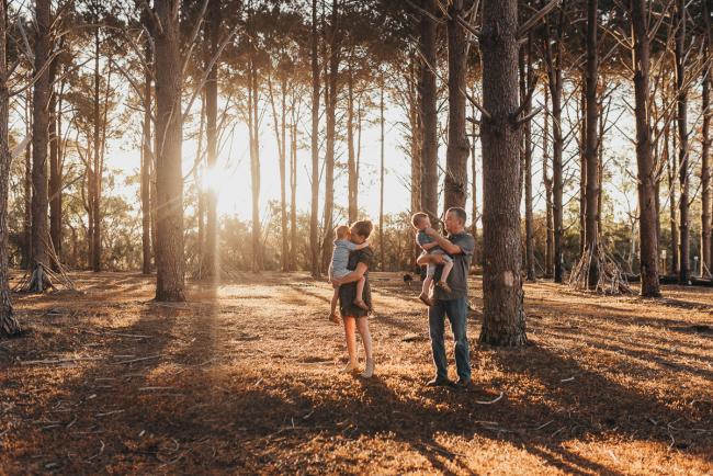 Family of four in golden hour during Perth family photography session at The Pines Perth with Alana Prosper Photography