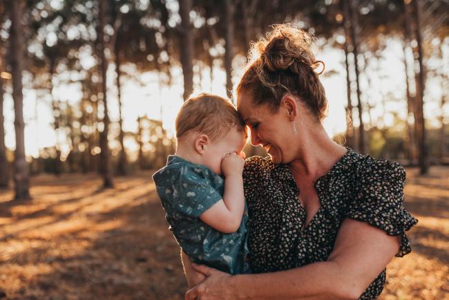 mother holding son who is rubbing his eyes during Perth family photography session at The Pines Perth with Alana Prosper Photography