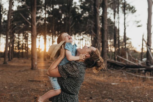 mother lifting son during Perth family photography session at The Pines Perth with Alana Prosper Photography