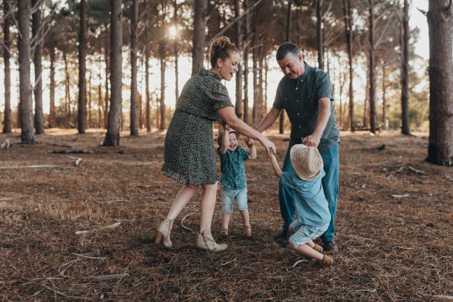 family playing ring a rosy during Perth family photography session at The Pines Perth with Alana Prosper Photography