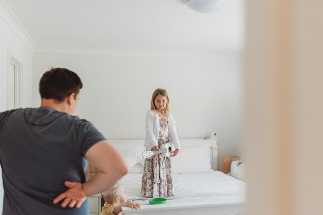 Perth-Newborn-Photographer-Alana-Prosper-Photography-1-of-31 little girl standing on bed with guitar with Perth lifestyle newborn photographer Alana Prosper Photography