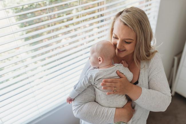Perth-Newborn-Photographer-Alana-Prosper-Photography-13-of-31 mother holding baby by window with Perth lifestyle newborn photographer Alana Prosper Photography