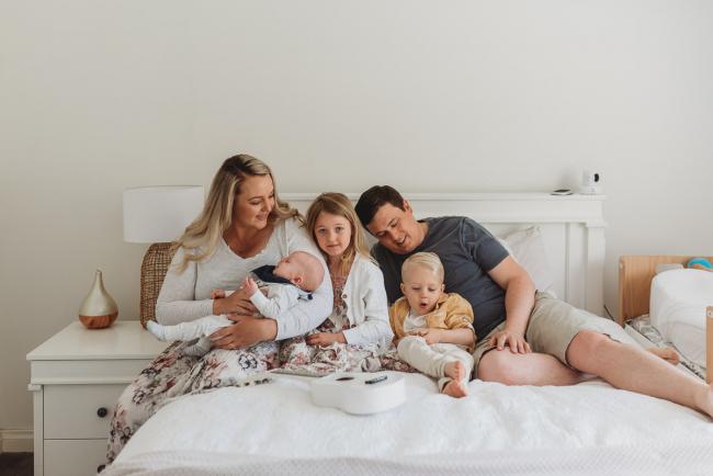 family of five on bed with Perth lifestyle newborn photographer Alana Prosper Photography