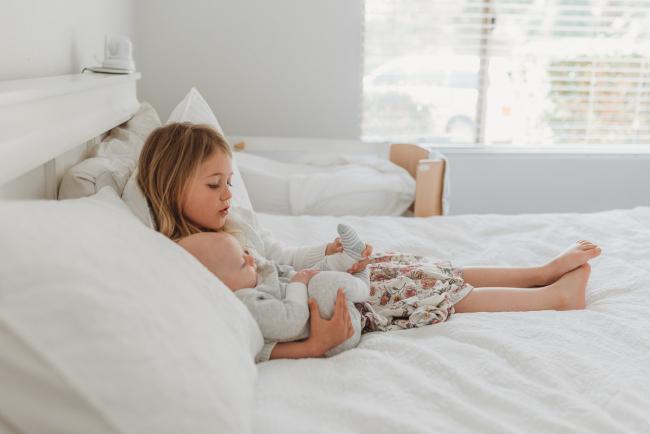 Perth-Newborn-Photographer-Alana-Prosper-Photography-9-of-31 little girl laying on bed with baby with Perth lifestyle newborn photographer Alana Prosper Photography