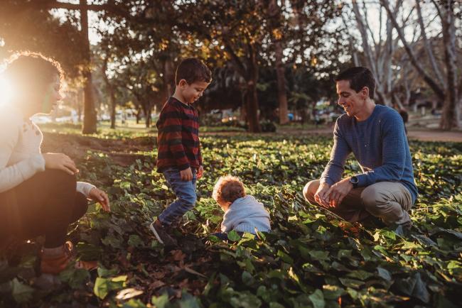 family of four in grass with Perth family photographer Alana Prosper Photography at Hyde Park