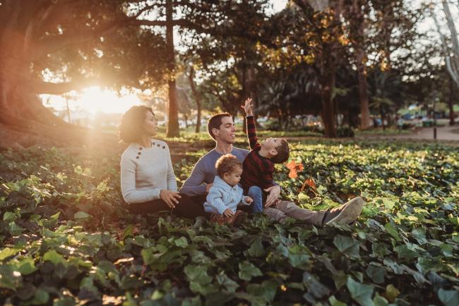 family of four in grass with Perth family photographer Alana Prosper Photography at Hyde Park
