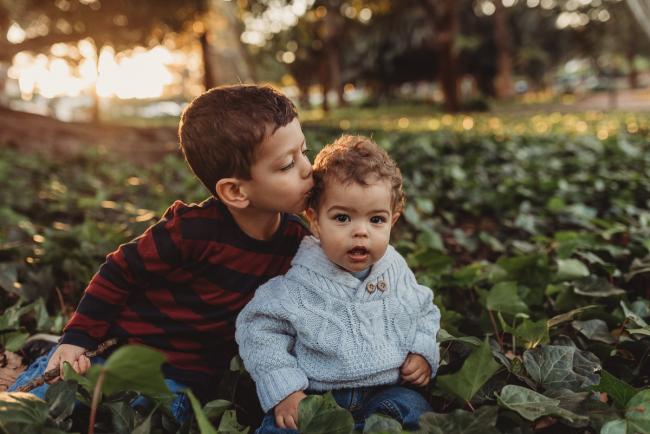 boy kissing younger brother with Perth family photographer Alana Prosper Photography at Hyde Park