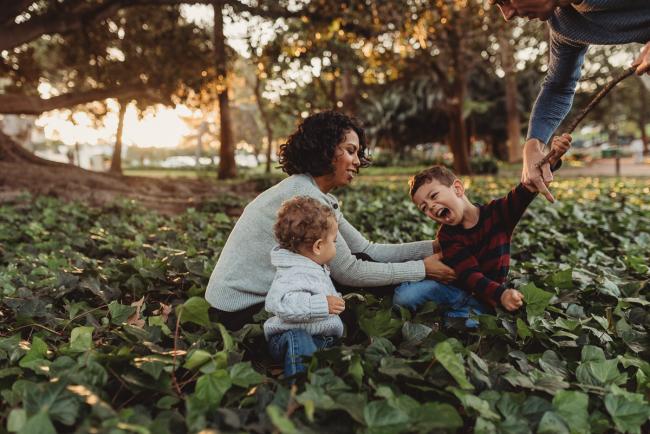 family in grass with Perth family photographer Alana Prosper Photography at Hyde Park