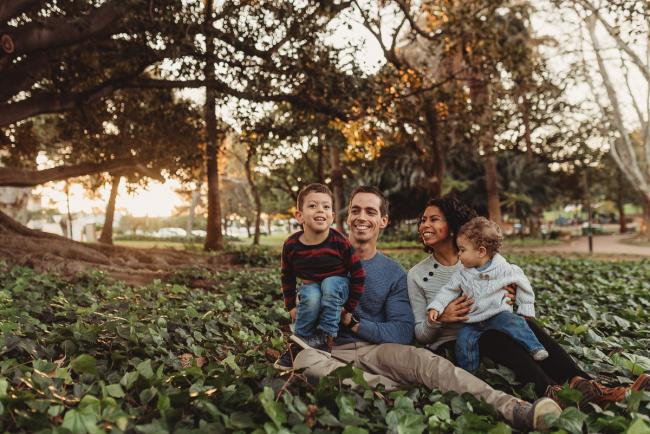 family of four in grass with Perth family photographer Alana Prosper Photography at Hyde Park