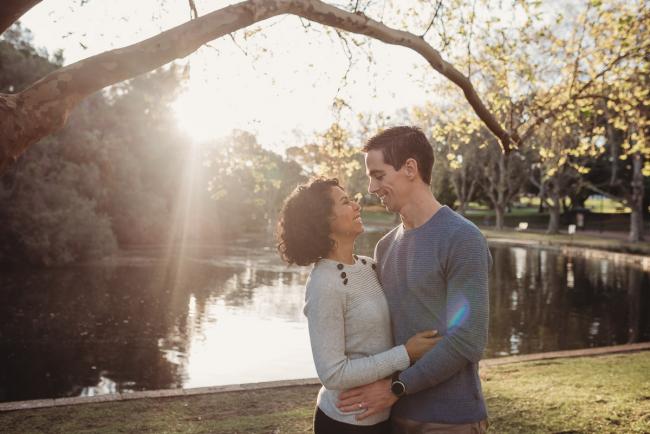 couple smiling at each other with Perth family photographer Alana Prosper Photography at Hyde Park